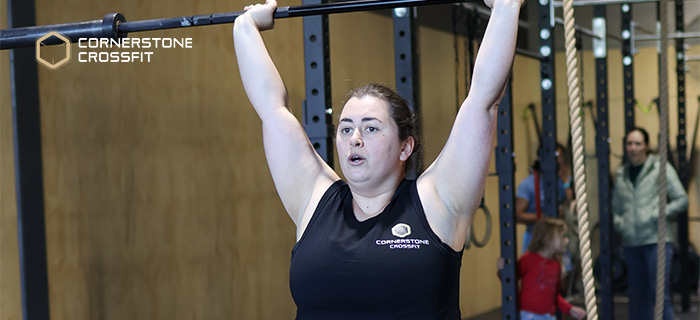 Person doing CrossFit workout in a gym during beginner training